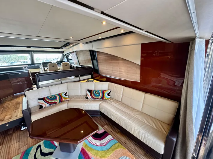 For Whom The Bell Tolls Yacht Photos Pics Luxurious interior of 2017 Sea Ray L590 yacht with plush seating and vibrant decor.