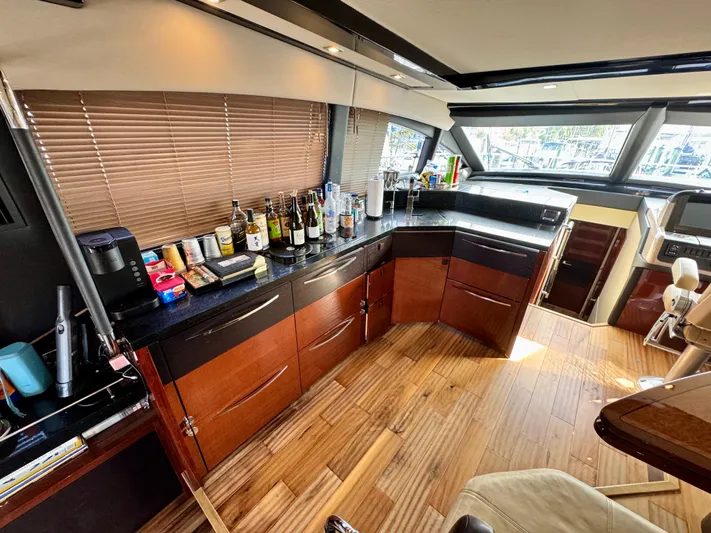 For Whom The Bell Tolls Yacht Photos Pics Luxurious interior of 2017 Sea Ray L590 yacht with modern kitchen and bar area.