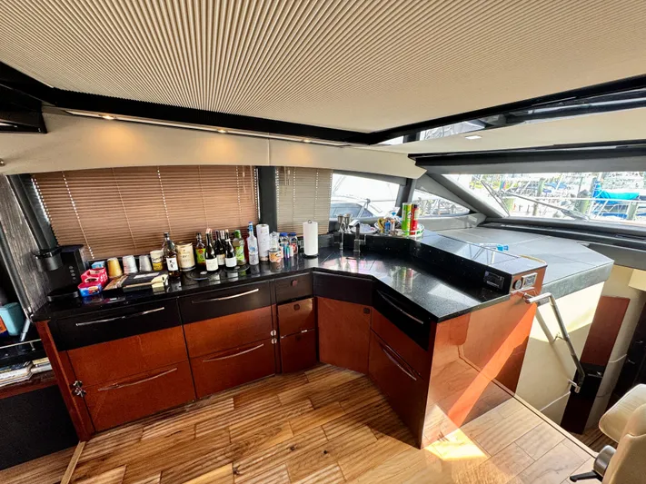 For Whom The Bell Tolls Yacht Photos Pics Luxurious interior of 2017 Sea Ray L590 yacht with modern kitchen and bar setup.