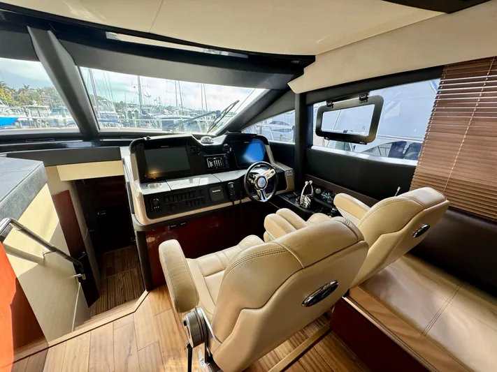 For Whom The Bell Tolls Yacht Photos Pics Luxurious 2017 Sea Ray L590 yacht helm with modern controls and plush seating.