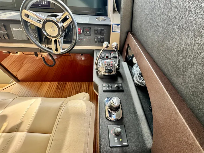 For Whom The Bell Tolls Yacht Photos Pics 2017 Sea Ray L590 helm with steering wheel, controls, and leather seating.