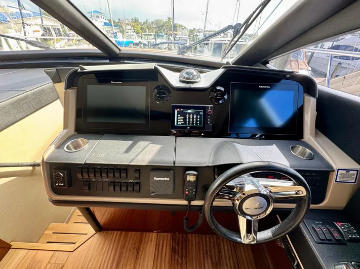 For Whom The Bell Tolls Yacht Photos Pics Helm of 2017 Sea Ray L590 yacht with dual screens and modern controls.