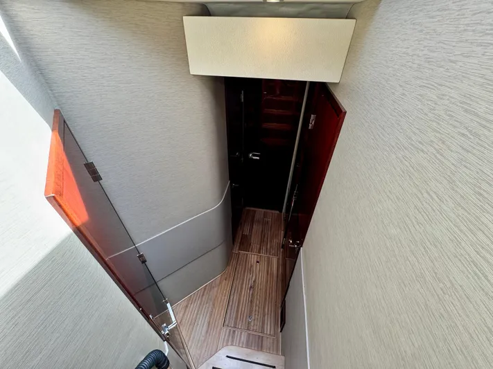 For Whom The Bell Tolls Yacht Photos Pics 2017 Sea Ray L590 yacht interior hallway with wooden flooring and modern design.