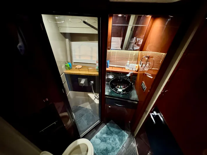 For Whom The Bell Tolls Yacht Photos Pics Luxurious bathroom interior of 2017 Sea Ray L590 yacht, featuring modern amenities and elegant design.