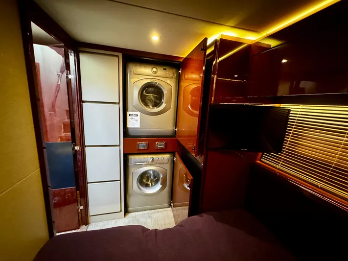 For Whom The Bell Tolls Yacht Photos Pics Laundry area inside 2017 Sea Ray L590 yacht with washer and dryer.