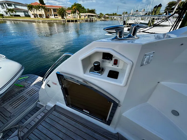 For Whom The Bell Tolls Yacht Photos Pics 2017 Sea Ray L590 yacht deck with control panel, docked by waterfront homes.