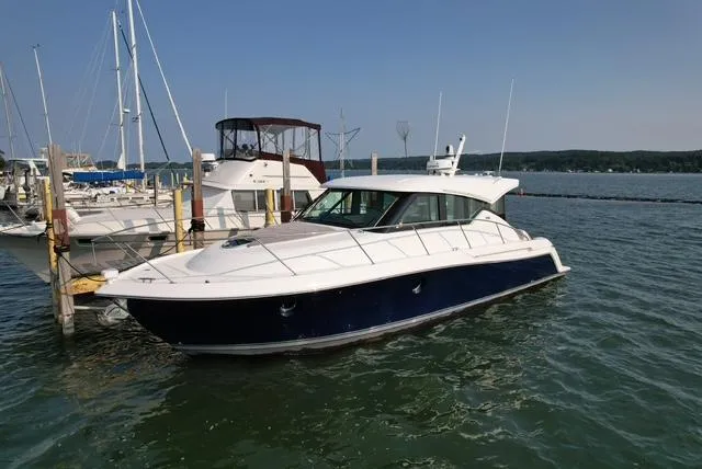  Yacht Photos Pics 2022 Tiara Yachts C39 Coupe docked in a marina, calm waters, clear sky.