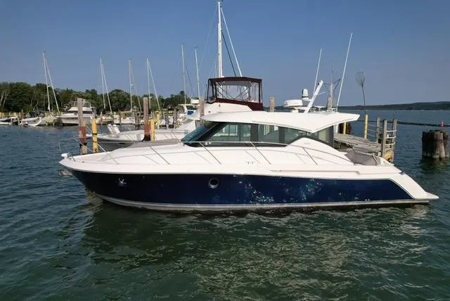  Yacht Photos Pics 2022 Tiara Yachts C39 Coupe docked in a marina, side view.