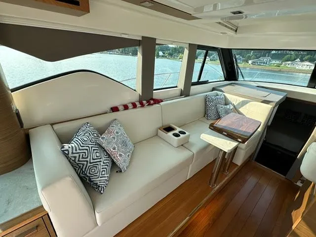  Yacht Photos Pics Luxurious interior of 2022 Tiara Yachts C39 Coupe with elegant seating and scenic window views.