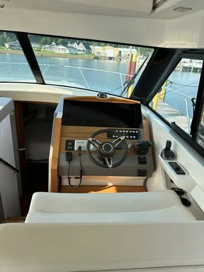  Yacht Photos Pics Interior helm of 2022 Tiara Yachts C39 Coupe, featuring modern controls and waterfront view.