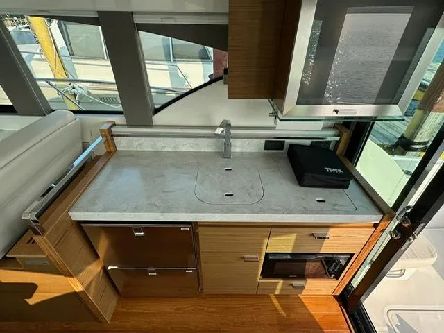  Yacht Photos Pics Modern kitchen interior of 2022 Tiara Yachts C39 Coupe with sleek countertops and cabinetry.