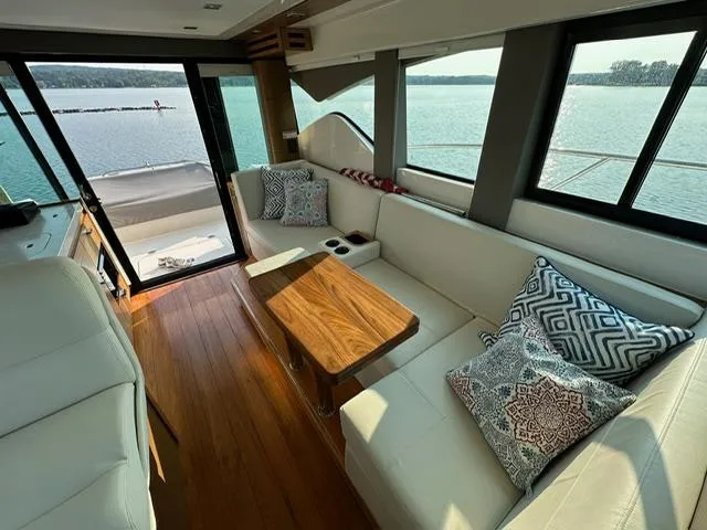  Yacht Photos Pics Interior of 2022 Tiara Yachts C39 Coupe with elegant seating and wooden table.