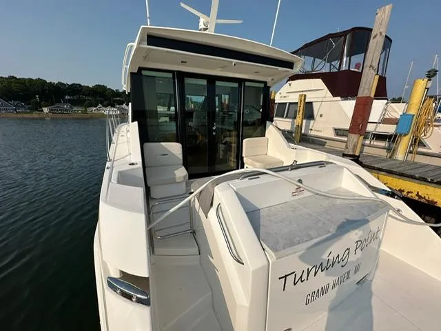  Yacht Photos Pics 2022 Tiara Yachts C39 Coupe docked, rear view with seating and glass doors.