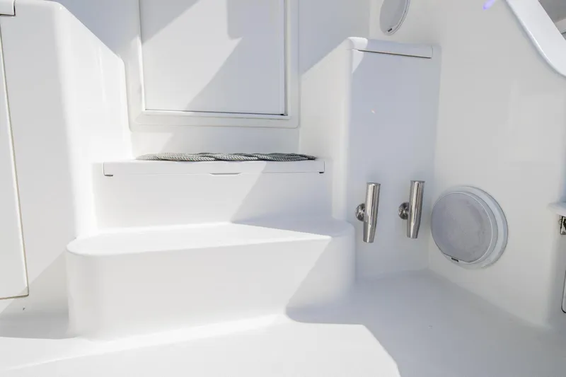 Triumph Yacht Photos Pics White interior of 1999 Viking 58 Enclosed Bridge yacht, featuring steps and storage compartments.