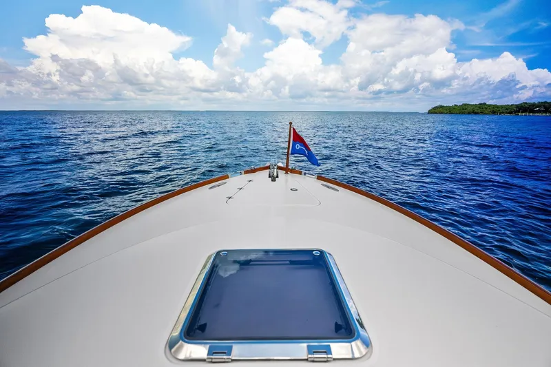 Capri Yacht Photos Pics Bow view of 2008 Hinckley Talaria 38R Convertible on open sea under blue sky.