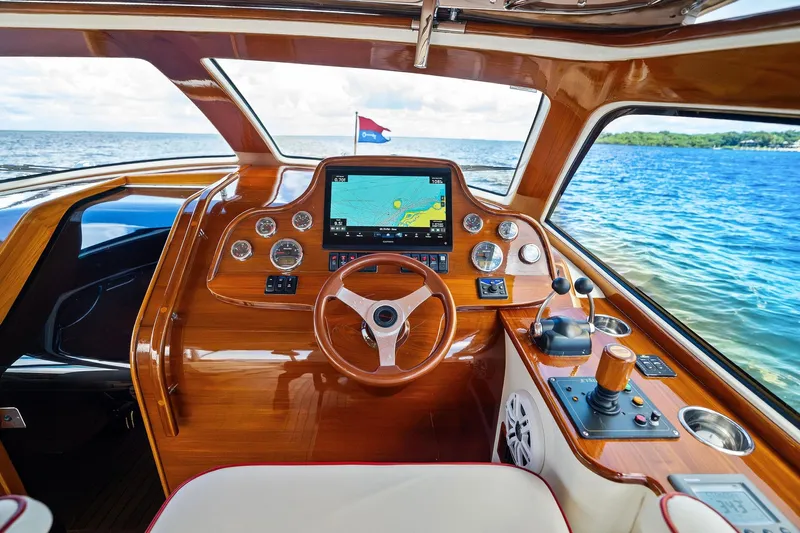 Capri Yacht Photos Pics 2008 Hinckley Talaria 38R Convertible helm with wooden dashboard and navigation system.