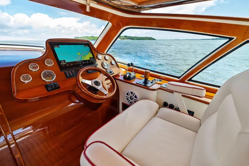 Capri Yacht Photos Pics Interior of 2008 Hinckley Talaria 38R Convertible yacht with wooden dashboard and ocean view.