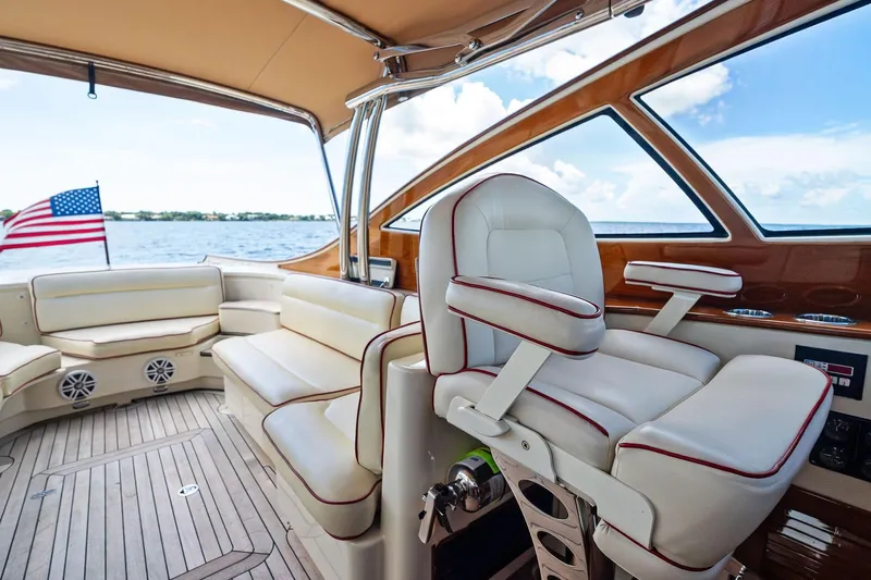 Capri Yacht Photos Pics Luxurious interior of 2008 Hinckley Talaria 38R Convertible yacht with elegant seating and American flag.