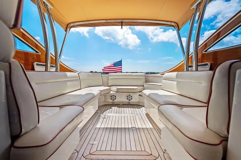 Capri Yacht Photos Pics Luxurious interior of 2008 Hinckley Talaria 38R Convertible yacht with American flag view.