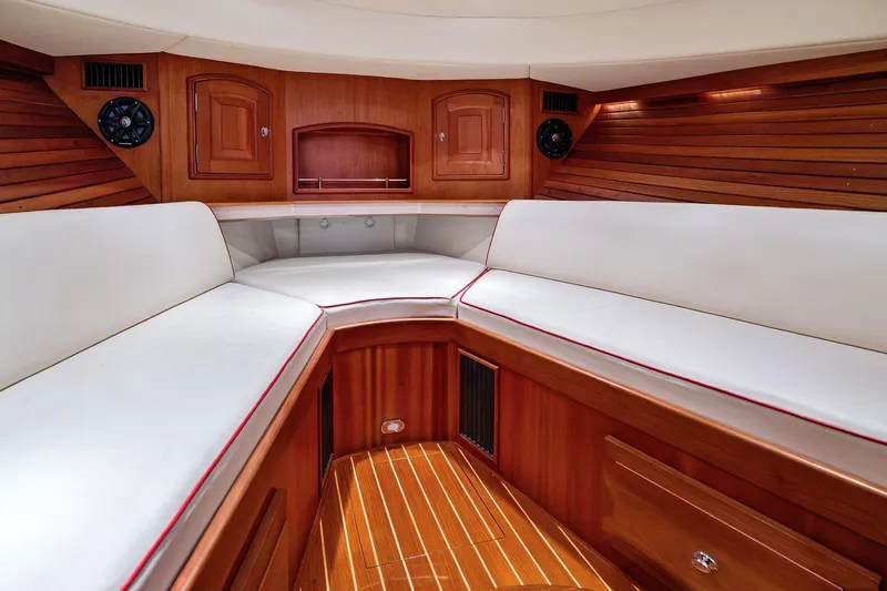 Capri Yacht Photos Pics Luxurious interior of 2008 Hinckley Talaria 38R Convertible with wood finish and white seating.