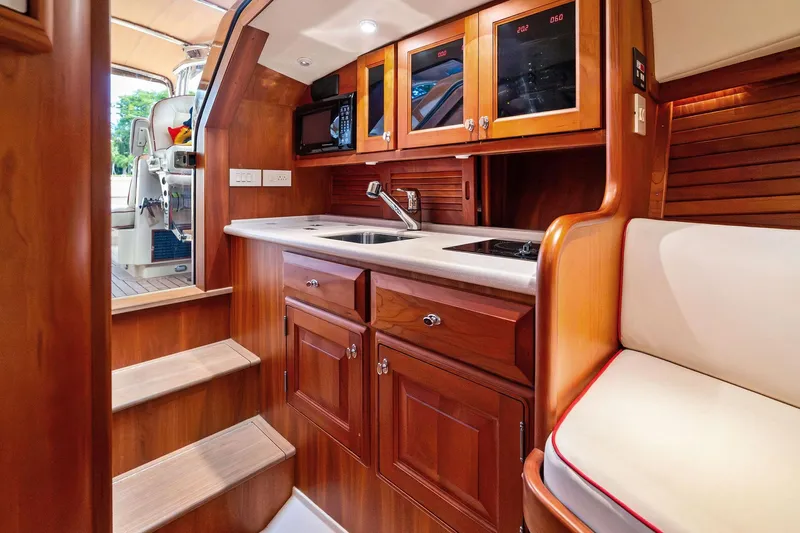 Capri Yacht Photos Pics Luxurious 2008 Hinckley Talaria 38R Convertible yacht interior with elegant wood cabinetry and modern amenities.