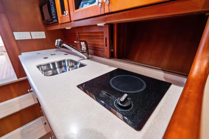 Capri Yacht Photos Pics Hinckley Talaria 38R Convertible 2008 yacht kitchen with sink and stovetop.