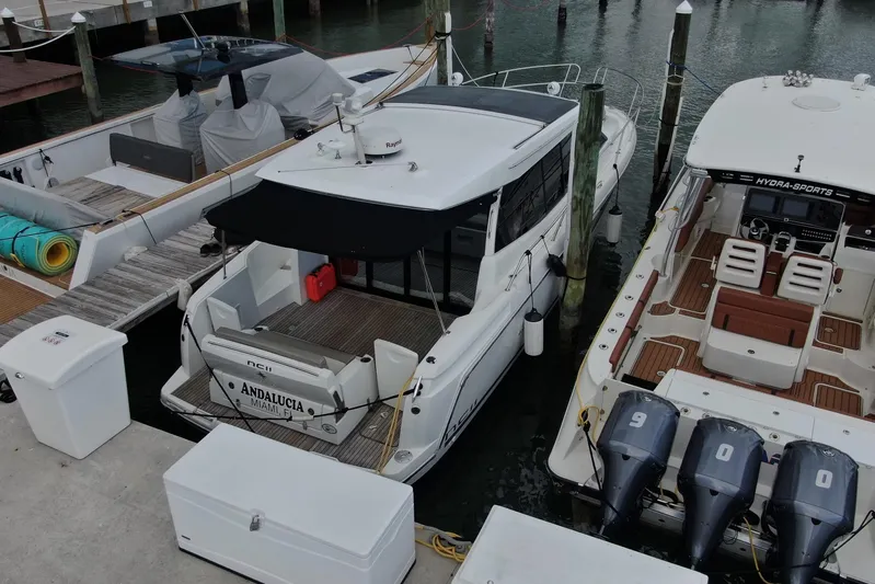 Andalucia Yacht Photos Pics 2017 Jeanneau NC 11 docked at marina, surrounded by other boats.