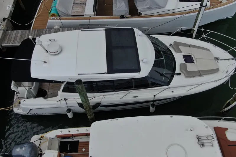 Andalucia Yacht Photos Pics Overhead view of a 2017 Jeanneau NC 11 boat docked at a marina.