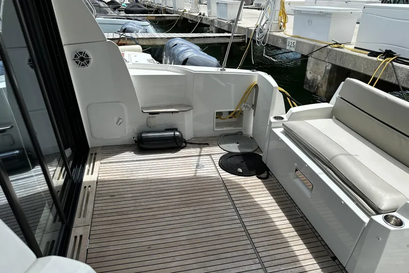 Andalucia Yacht Photos Pics 2017 Jeanneau NC 11 boat deck with seating, docked at marina.