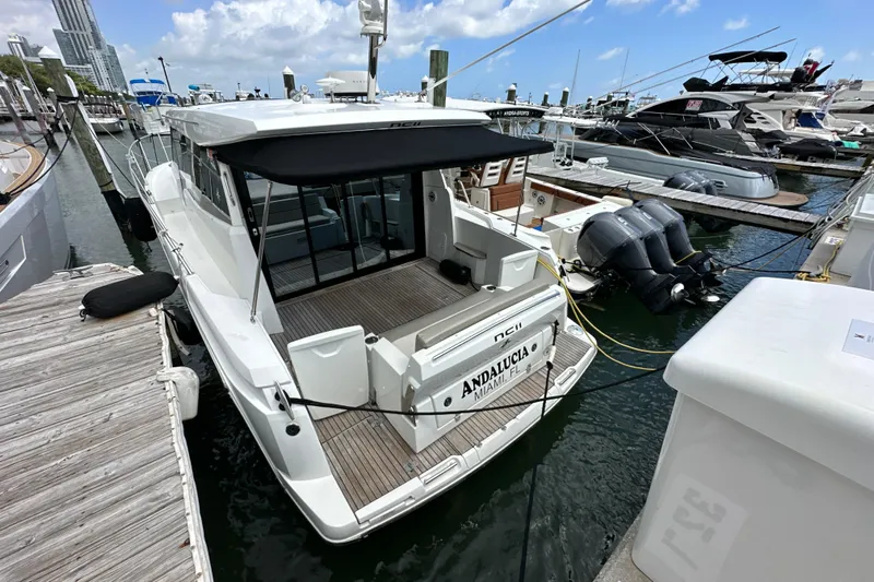 Andalucia Yacht Photos Pics 2017 Jeanneau NC 11 docked at marina, featuring spacious deck and modern design.