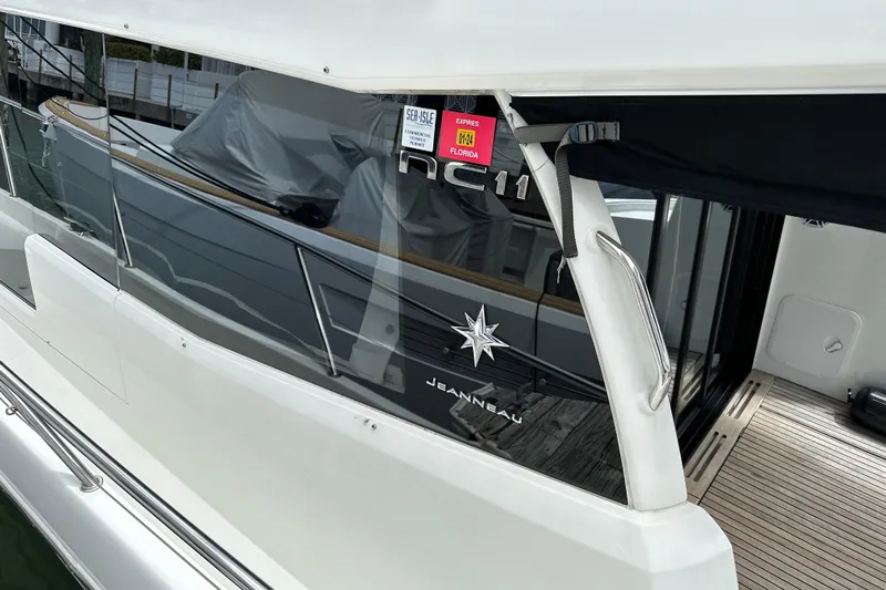Andalucia Yacht Photos Pics 2017 Jeanneau NC 11 boat, side view with branding and Florida registration sticker.