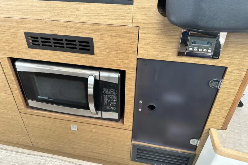 Andalucia Yacht Photos Pics 2017 Jeanneau NC 11 interior with built-in Danby microwave and control panel.