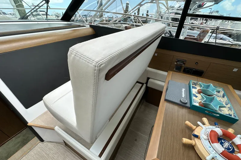 Andalucia Yacht Photos Pics Interior of 2017 Jeanneau NC 11 boat with helm seat and nautical decor.