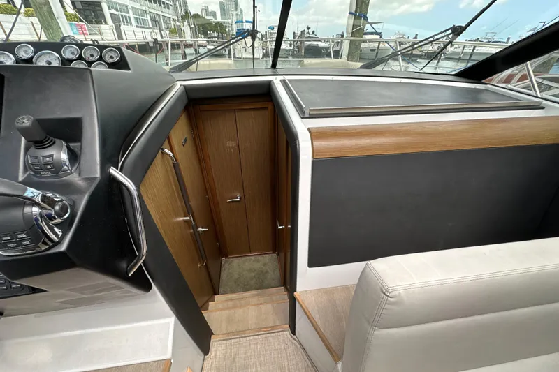 Andalucia Yacht Photos Pics Interior view of 2017 Jeanneau NC 11 boat cockpit with control panel and seating.