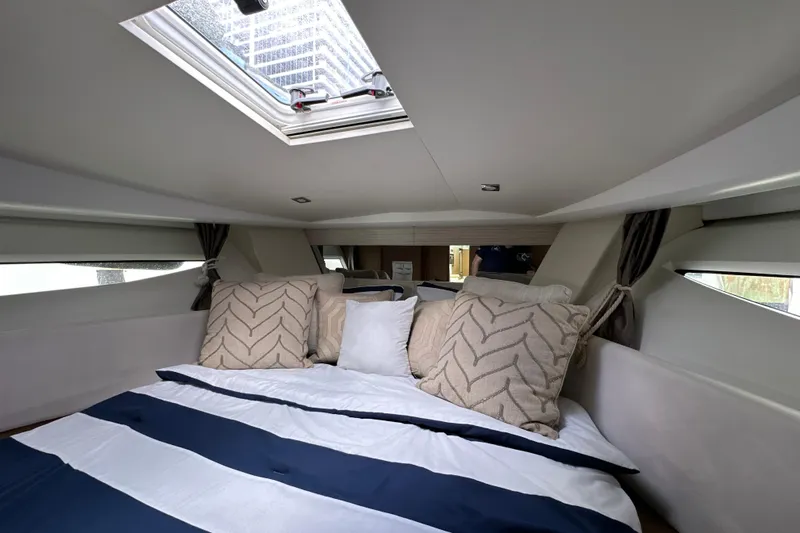 Andalucia Yacht Photos Pics Luxurious cabin interior of 2017 Jeanneau NC 11 with skylight and plush bedding.