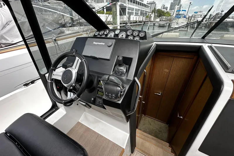 Andalucia Yacht Photos Pics 2017 Jeanneau NC 11 boat cockpit with steering wheel and navigation controls.