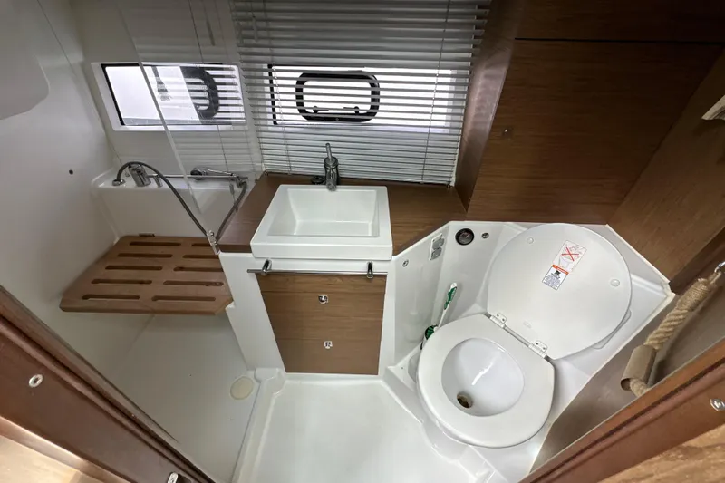 Andalucia Yacht Photos Pics Bathroom interior of 2017 Jeanneau NC 11 boat with sink and toilet.