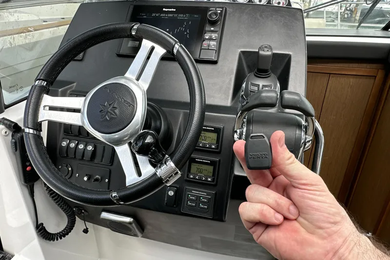 Andalucia Yacht Photos Pics Steering wheel and controls of a 2017 Jeanneau NC 11 boat cockpit.