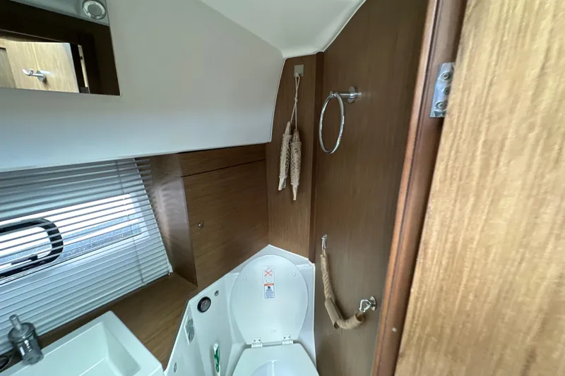 Andalucia Yacht Photos Pics 2017 Jeanneau NC 11 bathroom interior with wooden accents and modern fixtures.