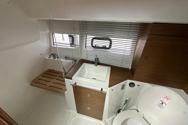 Andalucia Yacht Photos Pics Modern bathroom interior of 2017 Jeanneau NC 11 yacht with sink and toilet.