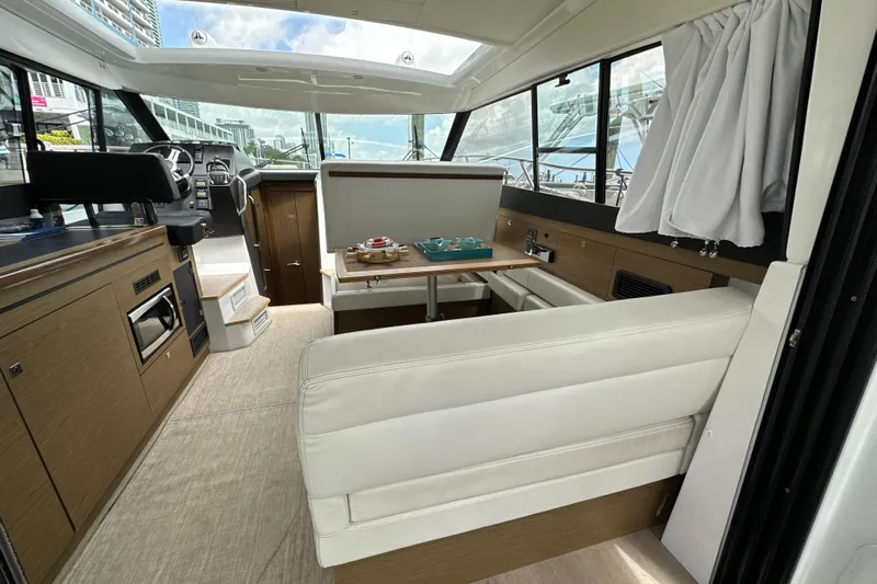 Andalucia Yacht Photos Pics Interior of 2017 Jeanneau NC 11 boat with modern seating and dining area.