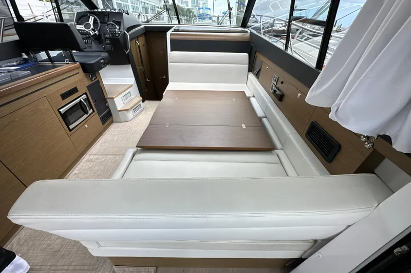 Andalucia Yacht Photos Pics Interior of 2017 Jeanneau NC 11 yacht with seating and helm station.