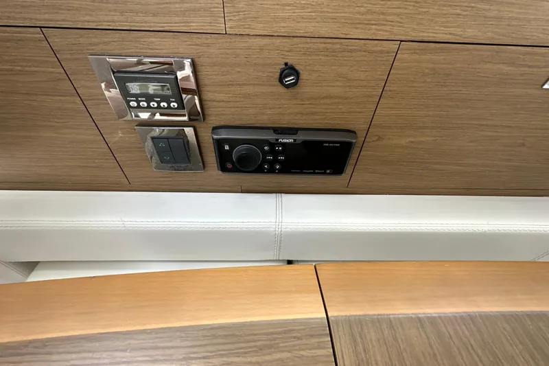Andalucia Yacht Photos Pics Control panel on 2017 Jeanneau NC 11 boat with wood finish and electronic controls.