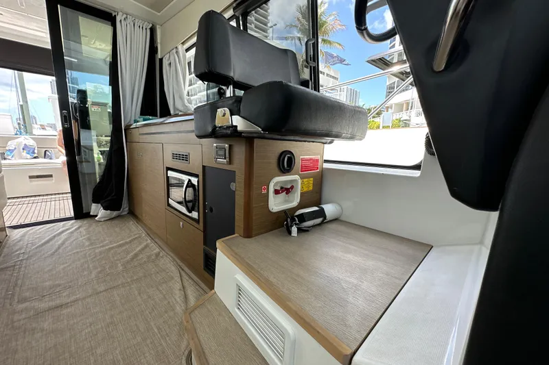 Andalucia Yacht Photos Pics Interior of 2017 Jeanneau NC 11 boat with modern seating and kitchenette.