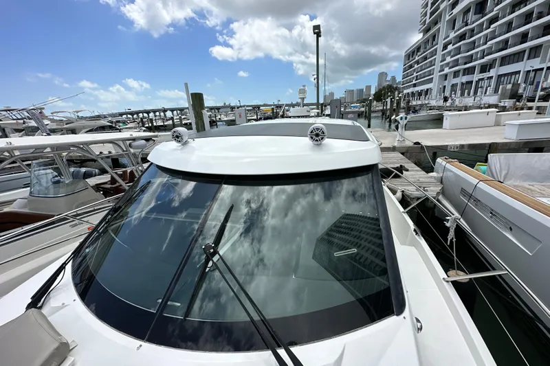 Andalucia Yacht Photos Pics 2017 Jeanneau NC 11 yacht docked at marina under blue sky.
