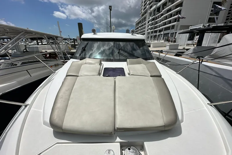 Andalucia Yacht Photos Pics 2017 Jeanneau NC 11 yacht with sunbathing cushions on deck, docked at marina.
