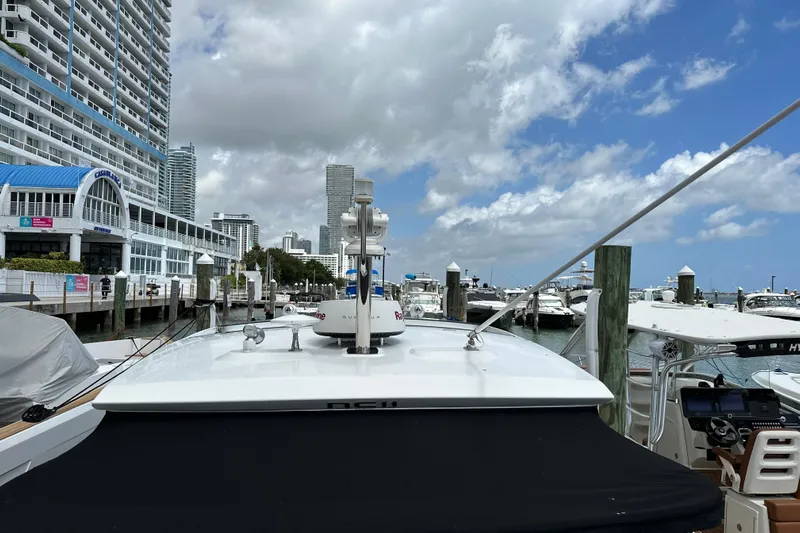 Andalucia Yacht Photos Pics 2017 Jeanneau NC 11 docked at a marina with cityscape background.
