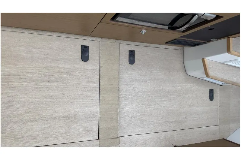 Andalucia Yacht Photos Pics Interior view of 2017 Jeanneau NC 11 boat, featuring wooden cabinetry and modern design.