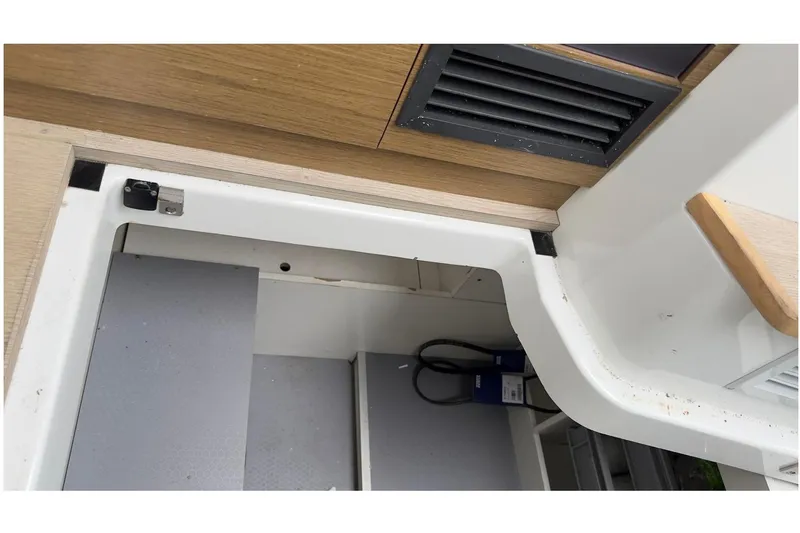 Andalucia Yacht Photos Pics Interior view of 2017 Jeanneau NC 11 boat showing storage compartment and vent.
