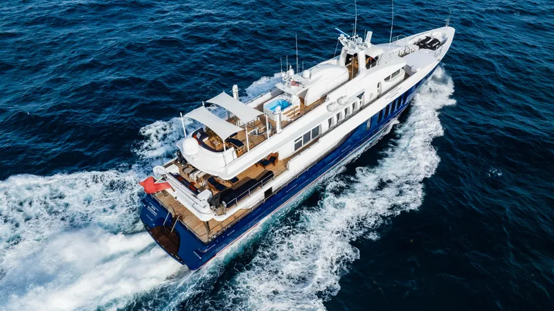 High Occupancy Yacht Photos Pics Luxurious 1989 Oceanfast Custom yacht cruising on open sea, aerial view.